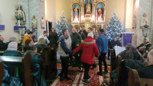 A gyerekek körbetáncolják az ajándékba kapott karácsonyfát